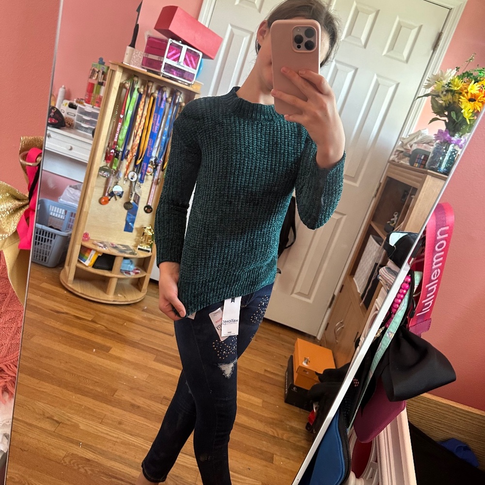 Green sweater with cross design on the back